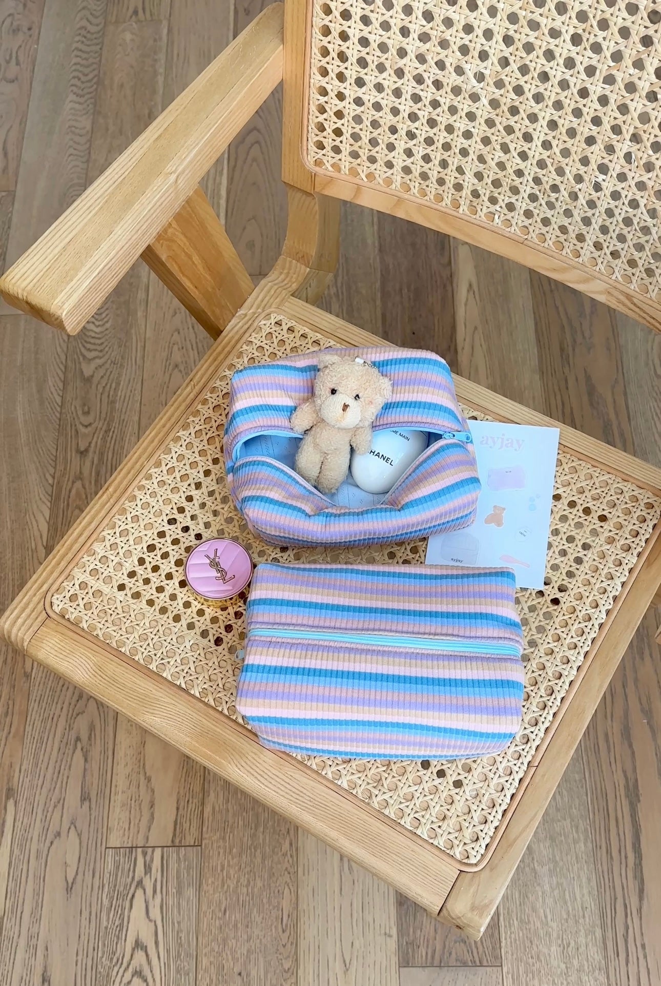Blue and purple striped fabric pouch with teddy charm, folded