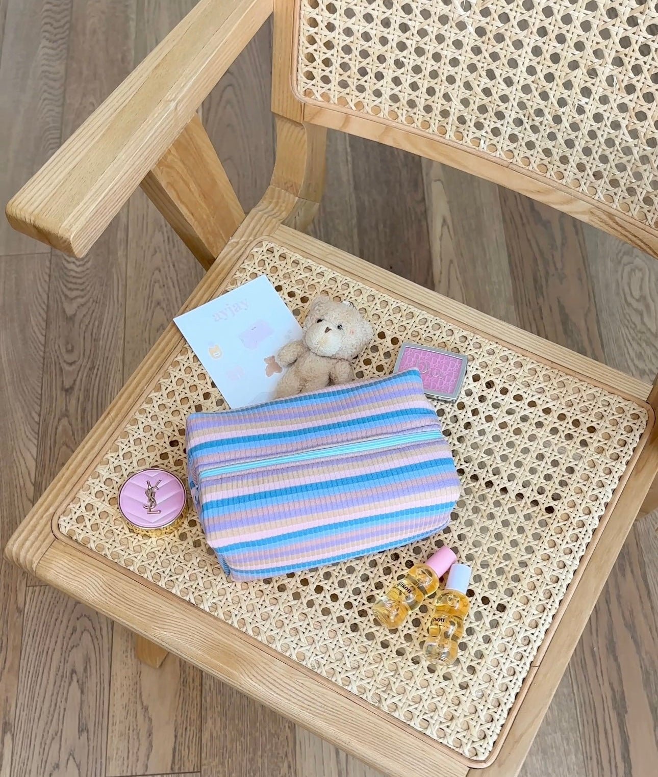 Blue and purple striped pouch with matching button and cards, folded