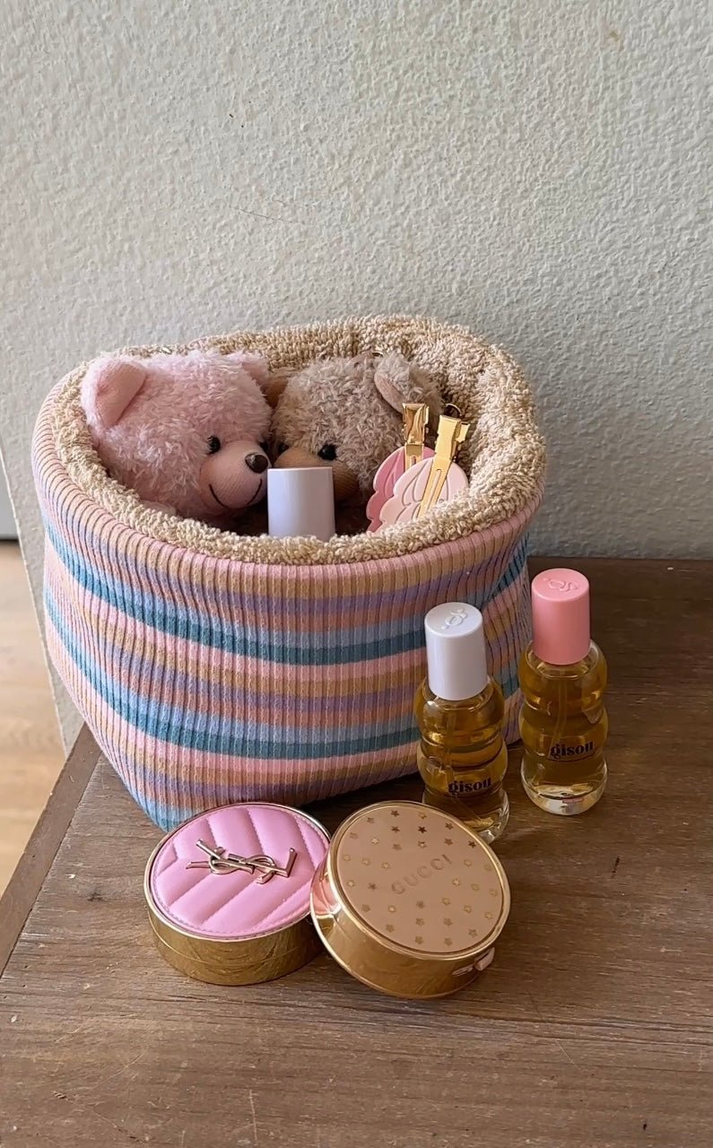 Pastel striped knit organizer with teddy bears peeking from top, beige plush trim
