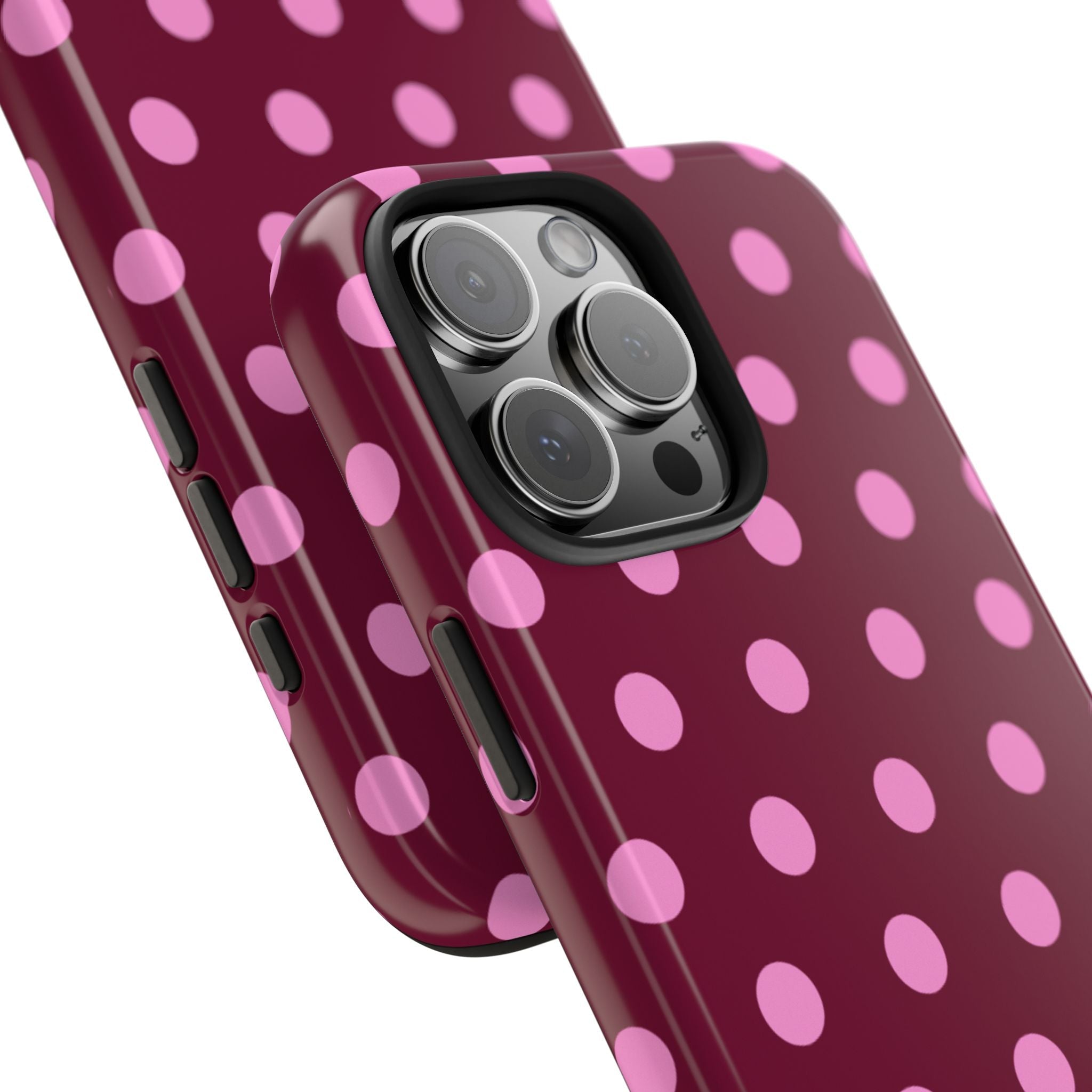 Raspberry pink polka dot phone case angled view with camera lenses and side grips