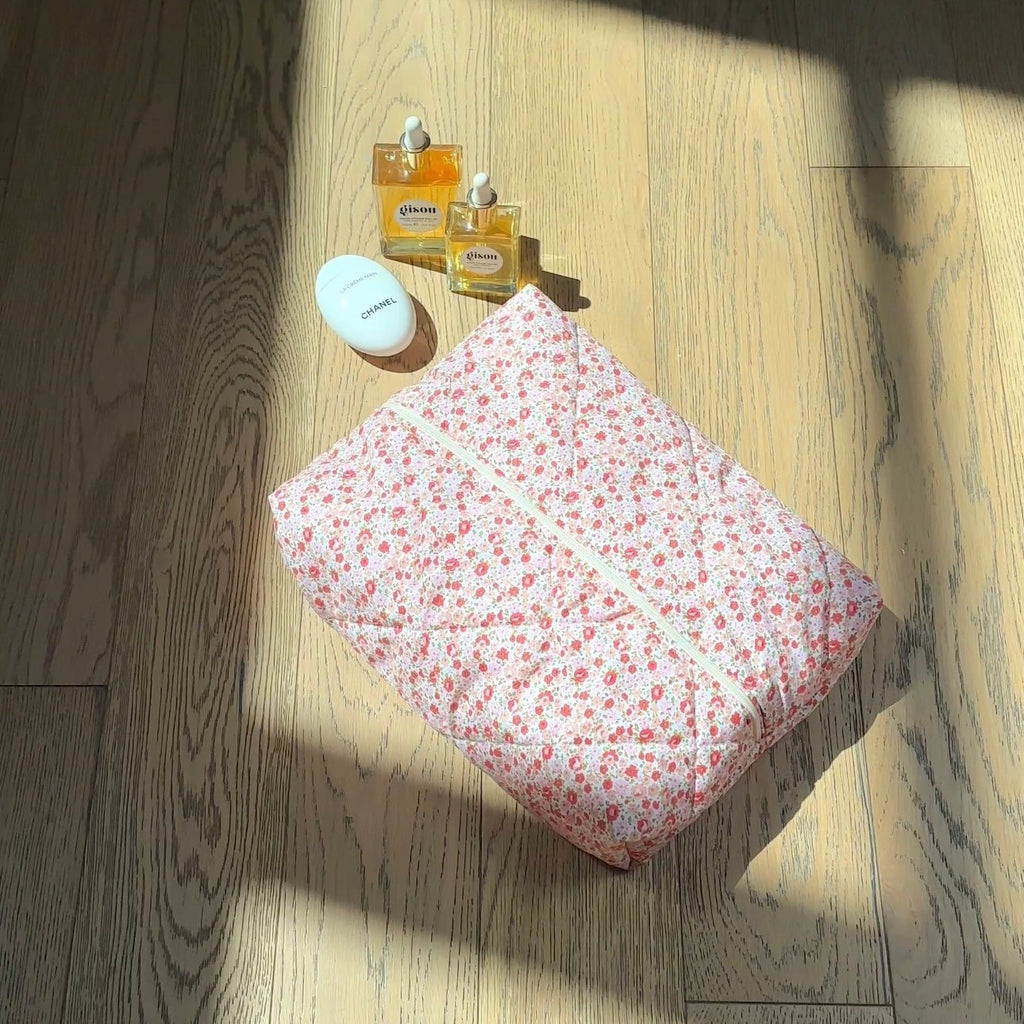 Floral zip pouch closed with loop handle, viewed from above