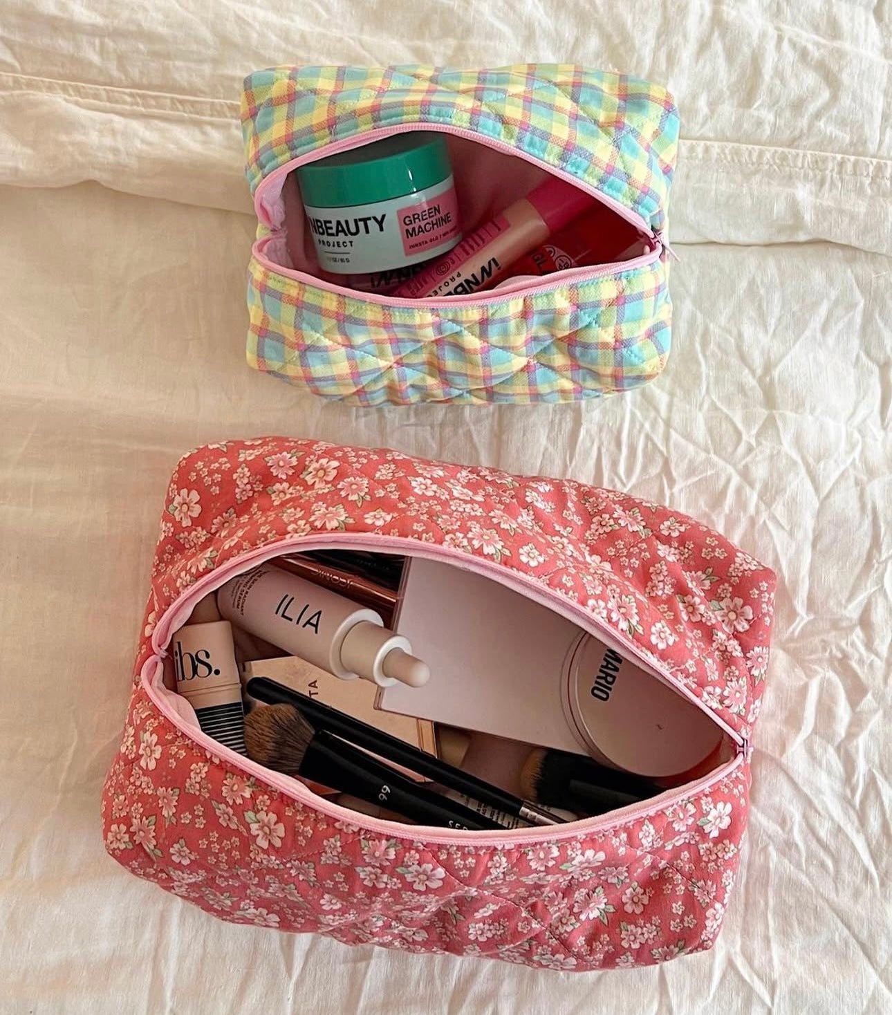 Red floral zip pouch, open top showing cosmetics inside