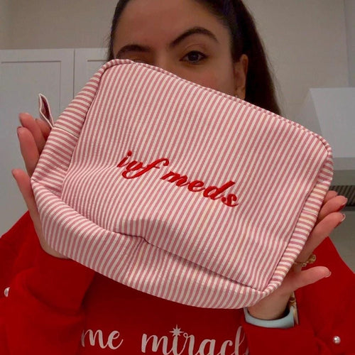 Red-and-white striped pouch with red script embroidery on front