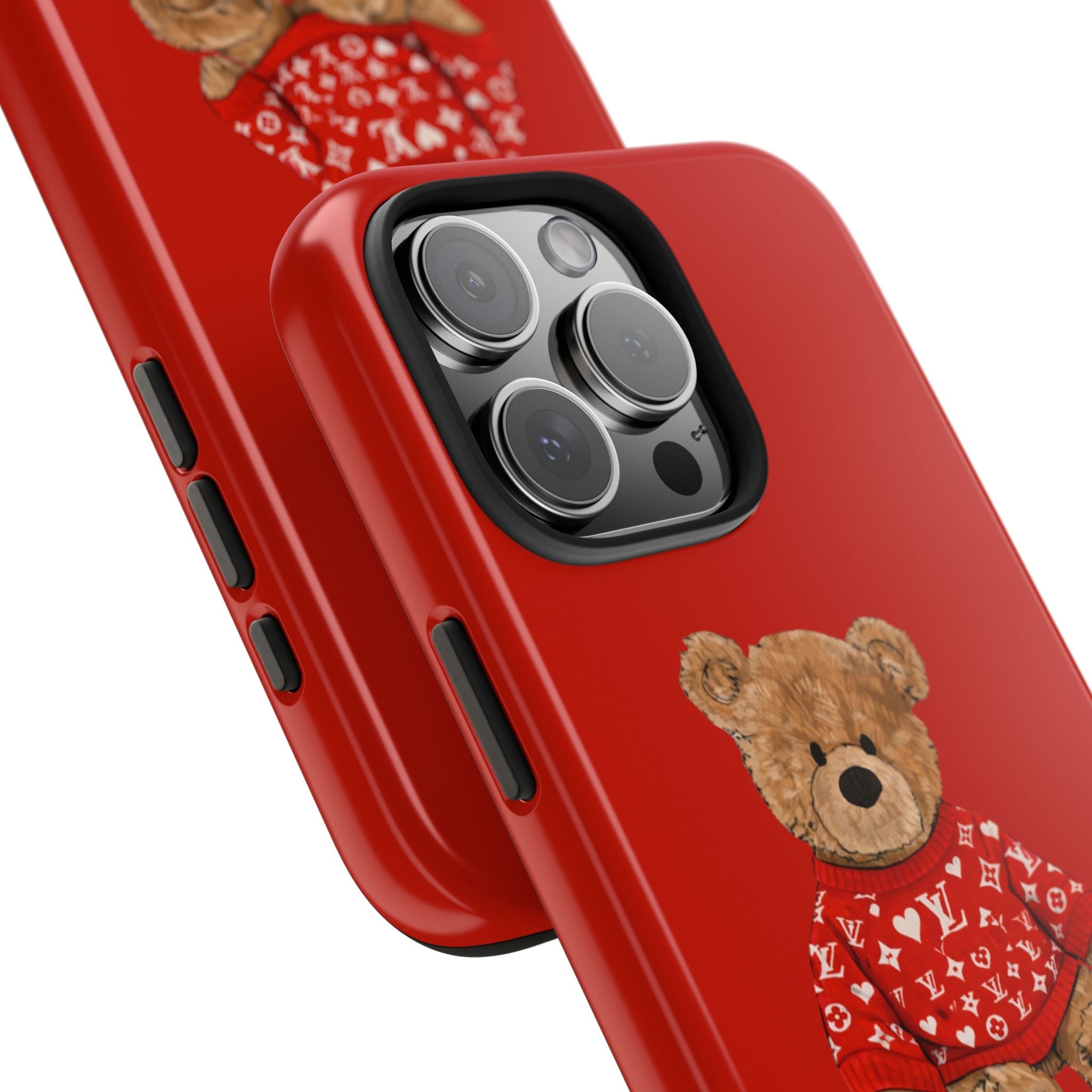 Red phone case close-up: teddy bear sweater graphic and raised camera lenses