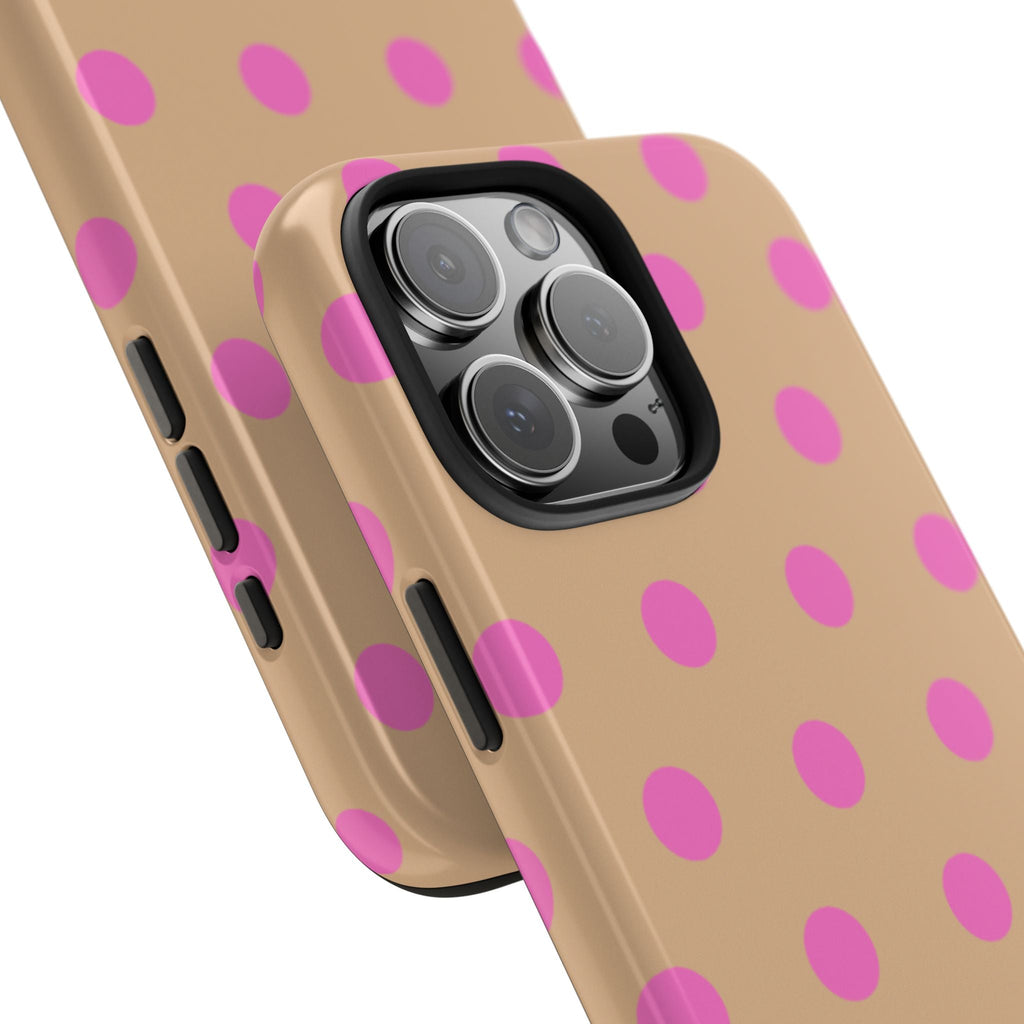 Angled view of rose beige phone case with pink polka dots, protected camera lenses