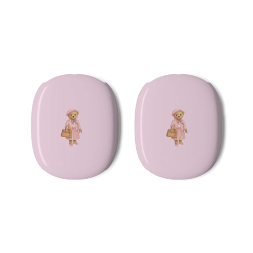 Two pink ear cup covers featuring teddy bear girl graphic on glossy surfaces.