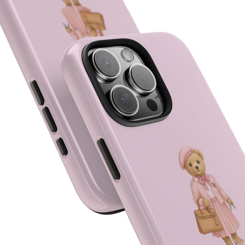 Pink case detail: teddy bear with handbag beside side buttons and camera lenses