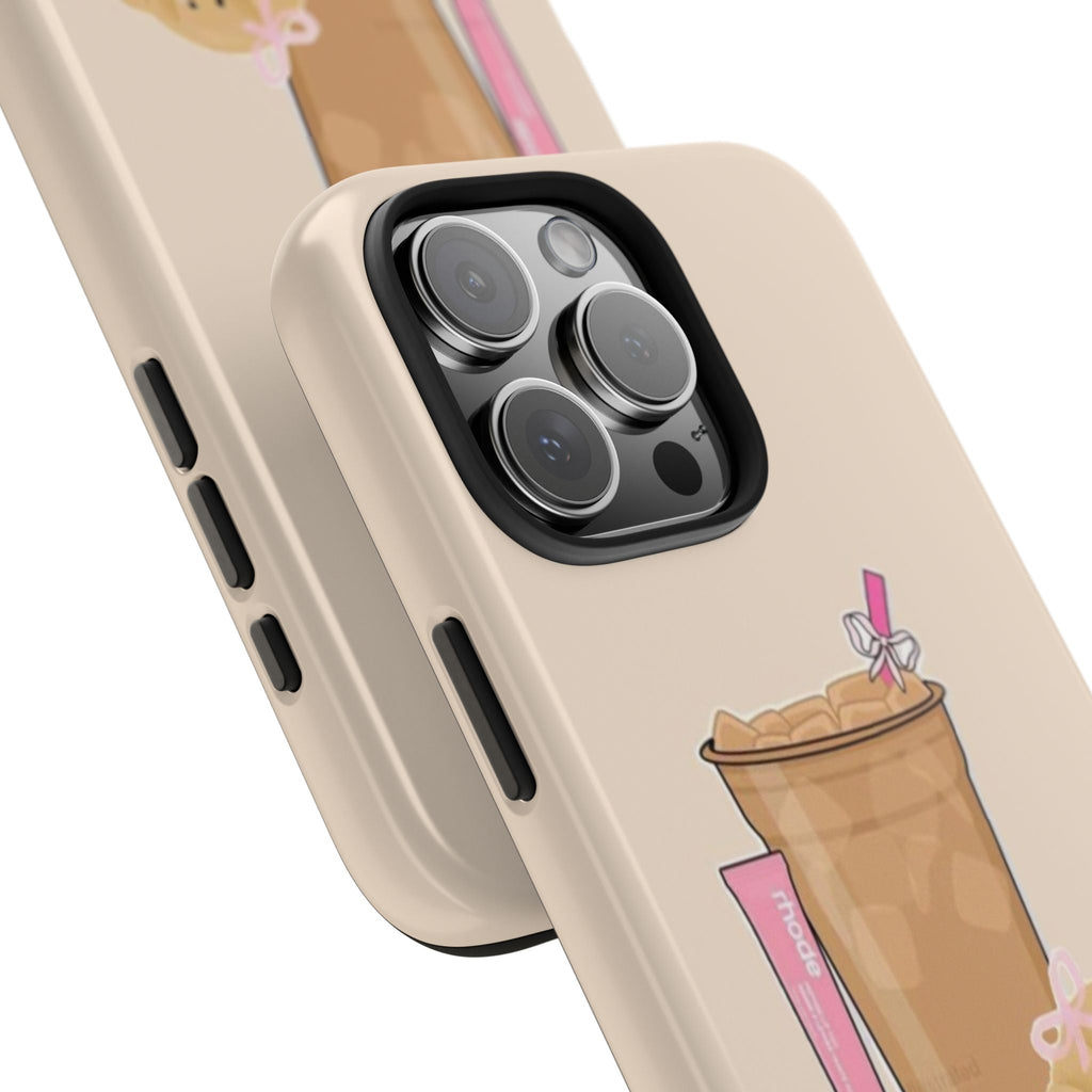Close-up beige phone case corner: camera lenses ringed, side buttons, drink graphic.