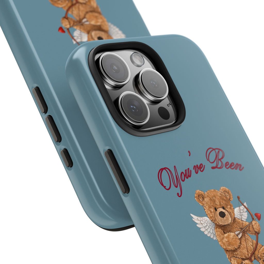 Slate blue phone case corner close-up with bear cupid graphic near camera module