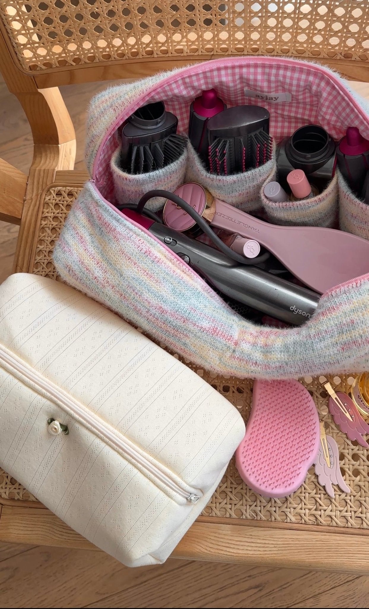 Pastel rainbow tie-dye hairtool bag with pink gingham lining, open to show brush heads