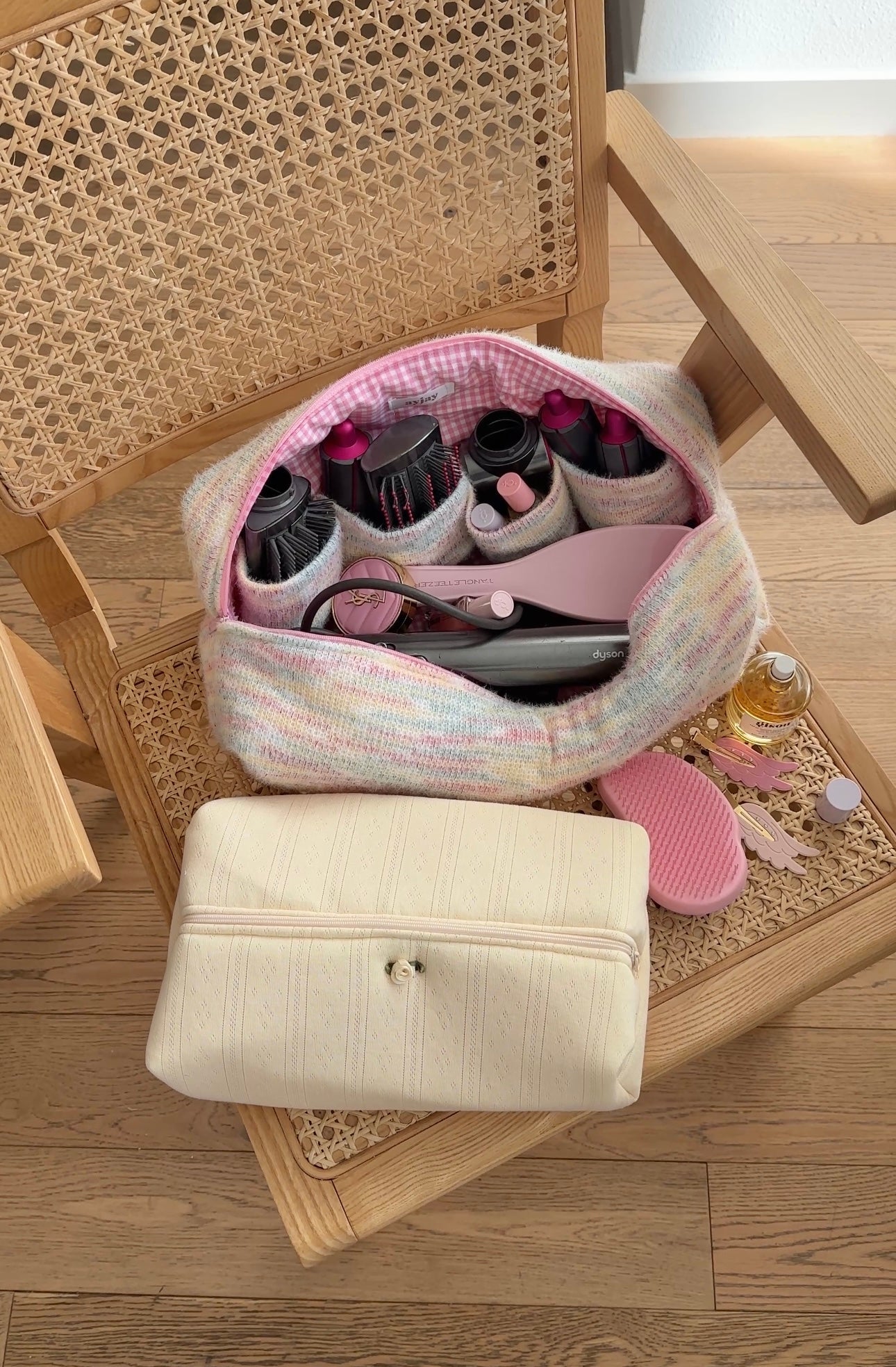 Pastel tie-dye hairtool bag with pink-lined interior, open to show brushes and attachments