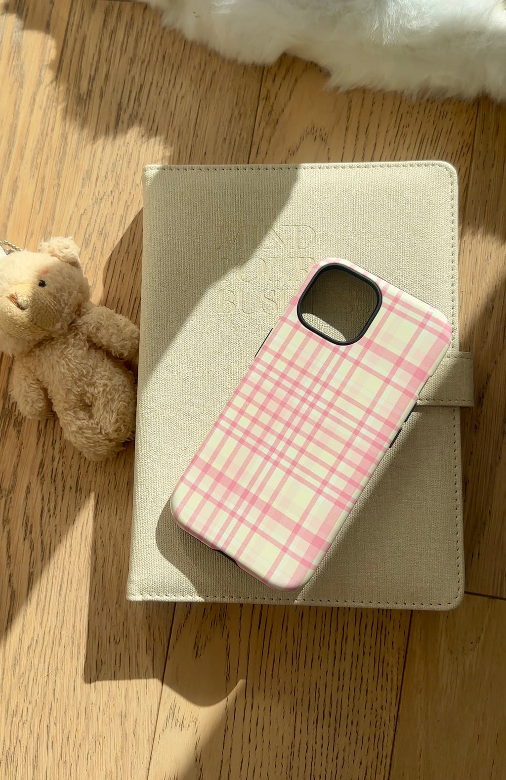 Plaid phone case with folio cover and pink/cream check design, card-slot style