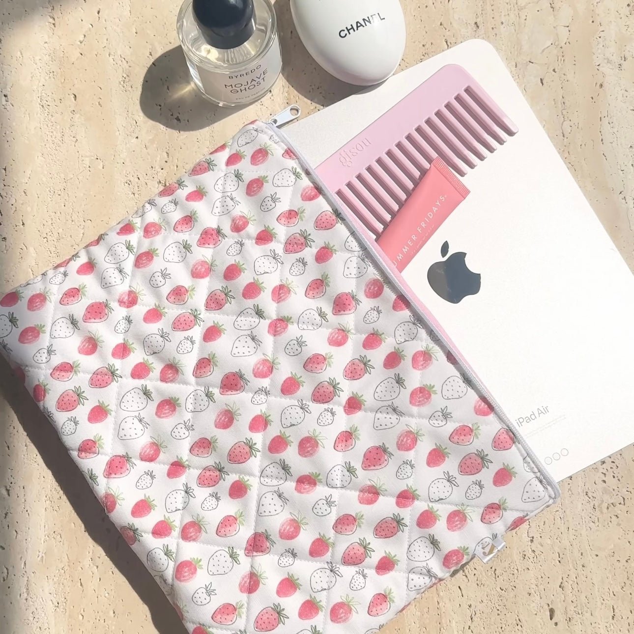 Strawberry-print iPad sleeve with pink-lined interior and elastic strap