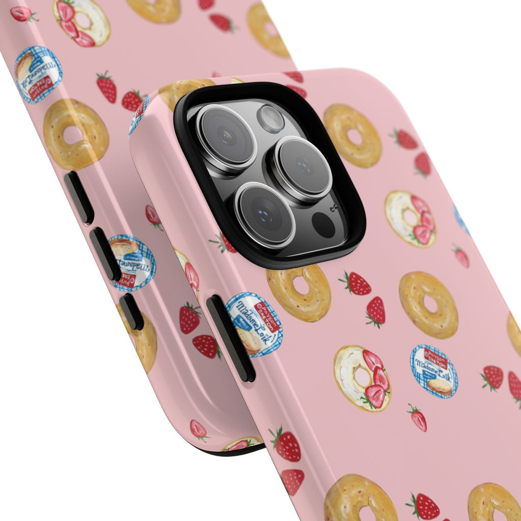 Angled pink phone case with strawberry-bagel print and camera lens protection ring