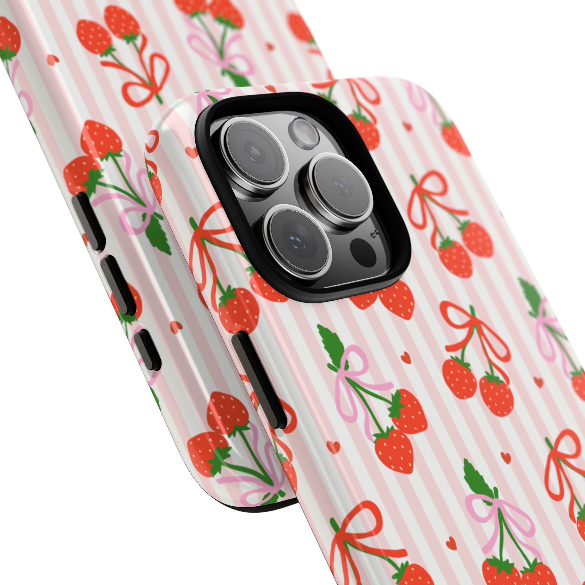 Side view of strawberry bows and pink striped phone case with raised camera bump