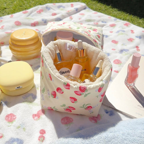 Strawberry floral organizer pouch, open top with small bottles and lip balm