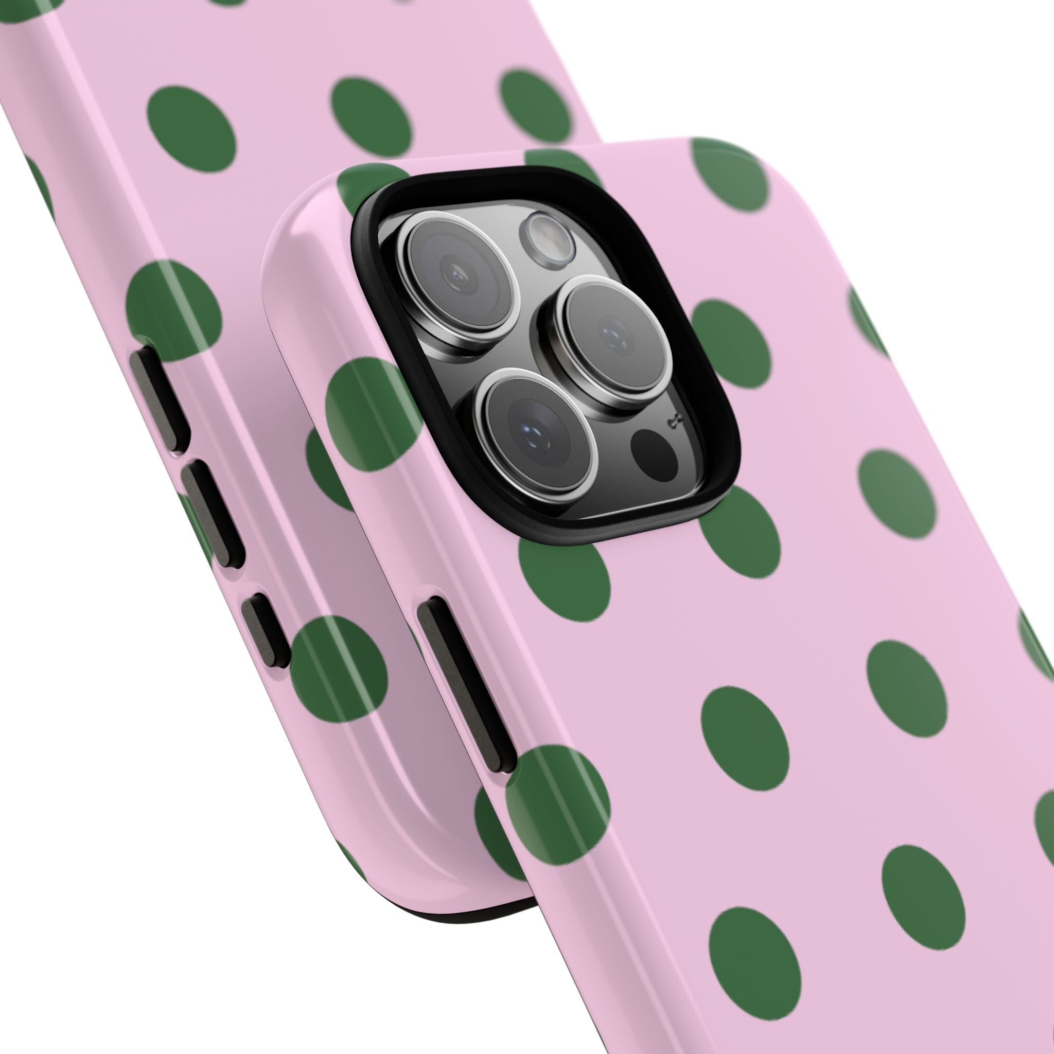 Angled view of pink phone case with green polka dot pattern and camera lenses