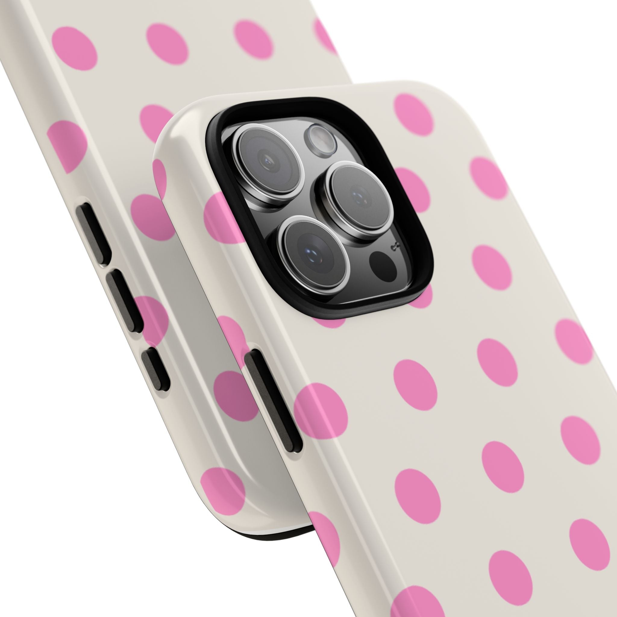 Angled close-up of strawberry milk polka dot phone case, pink dots and camera cutout