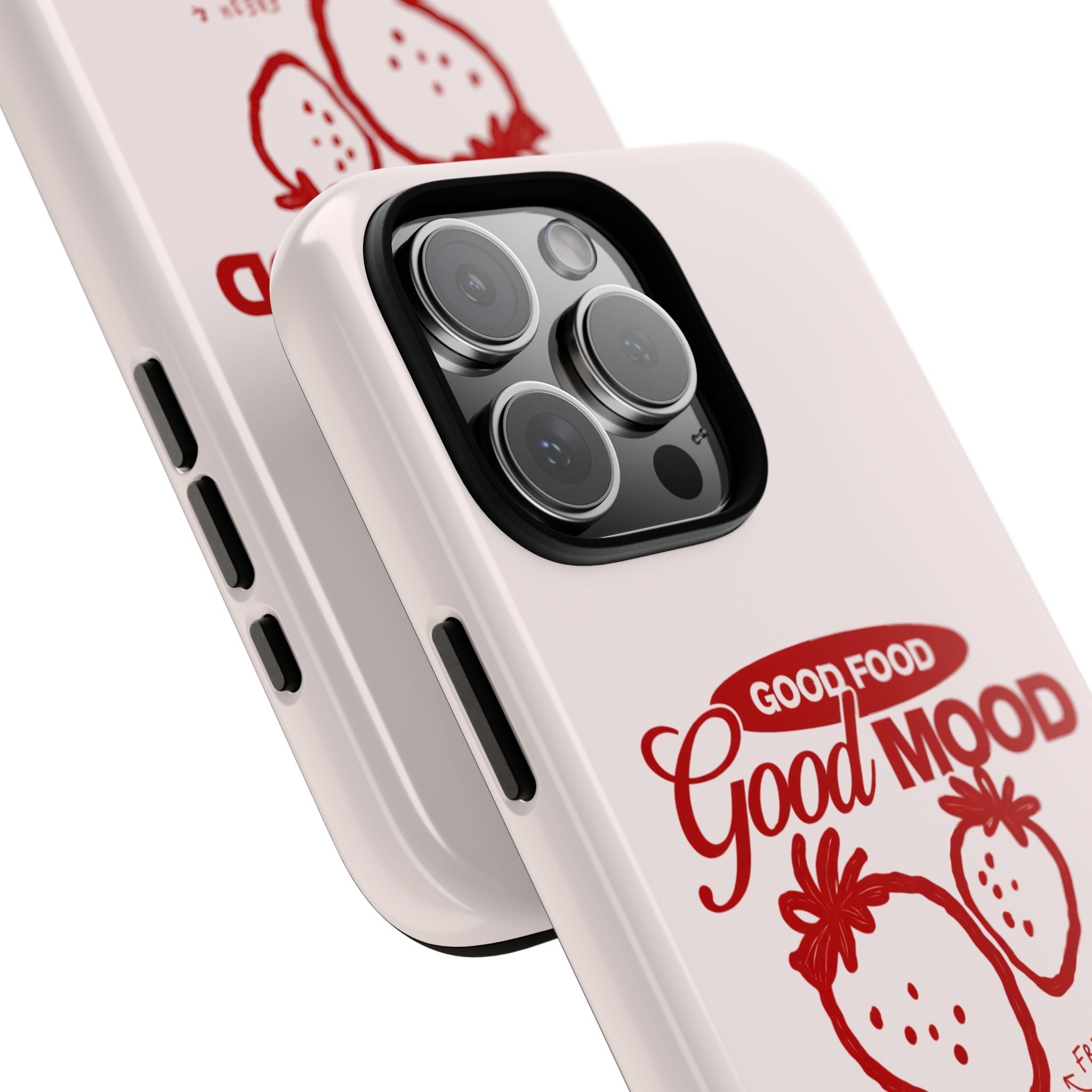 Angled close-up of light pink strawberry “Good Mood” phone case with camera lenses