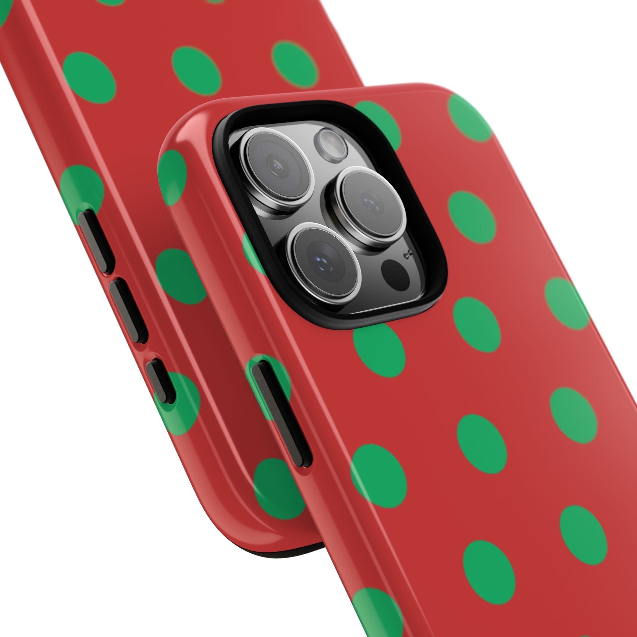Close-up strawberry polka dot phone case showing raised camera lenses on red