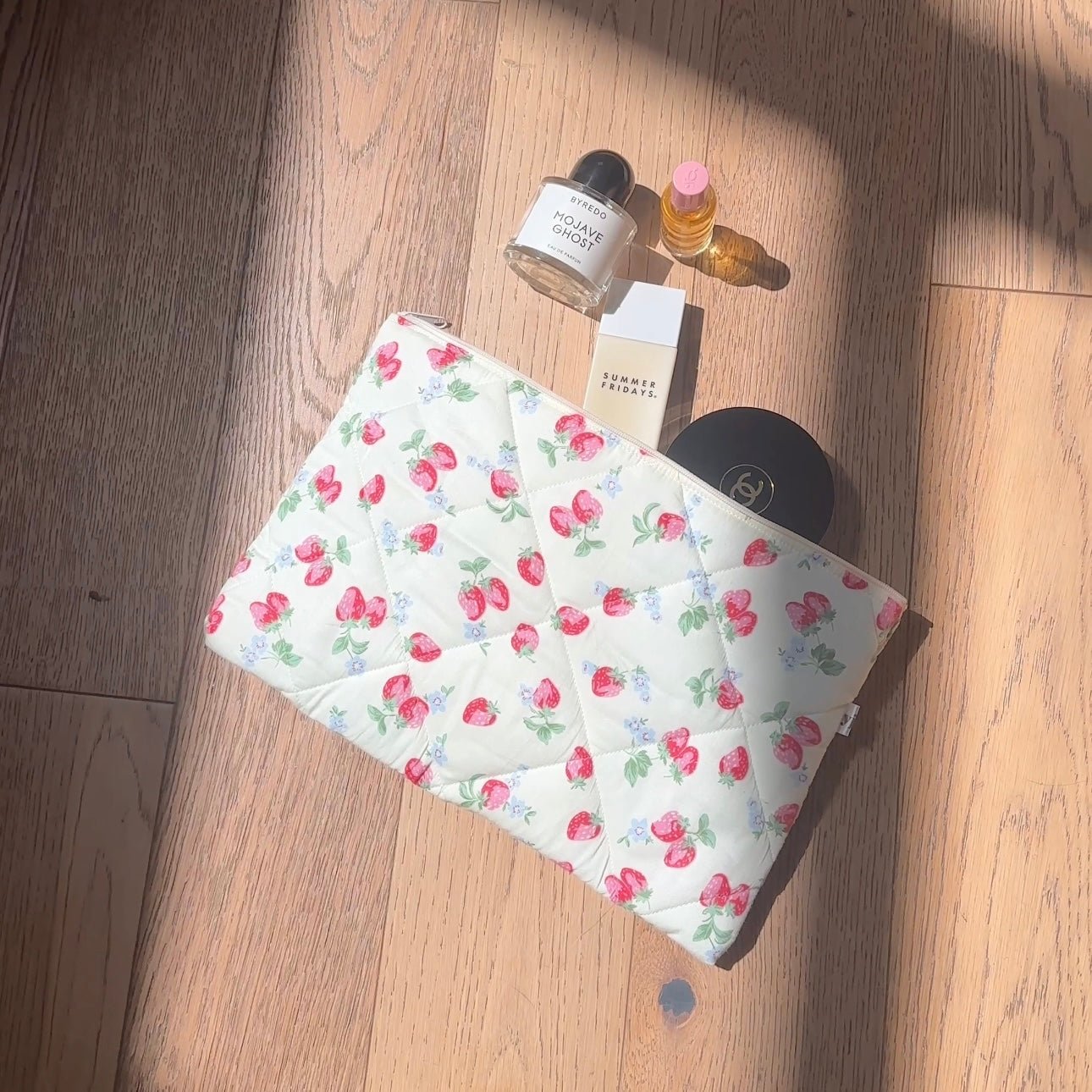 Padded iPad sleeve in white with pink strawberry floral print and green leaves