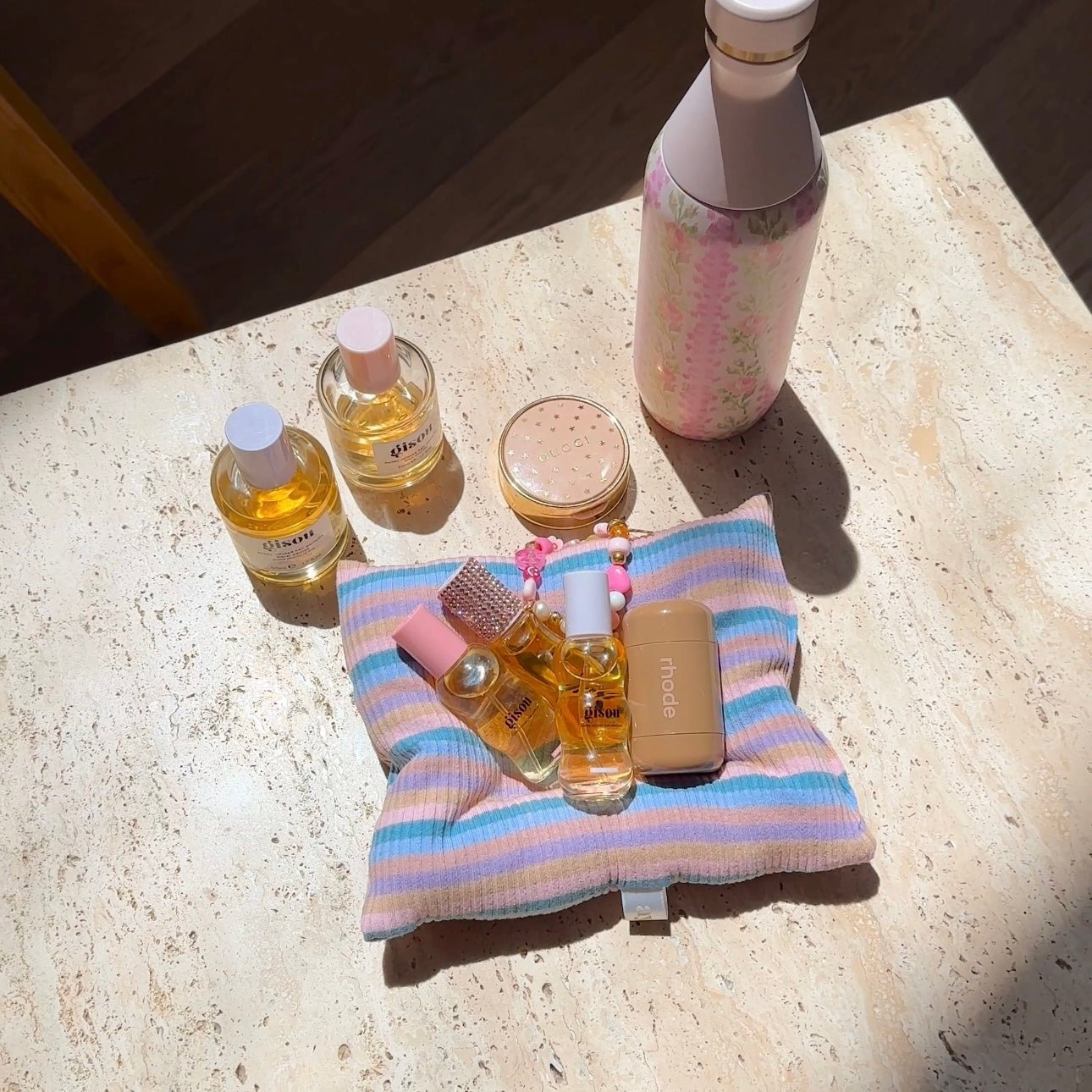 Striped coaster with pastel blue and pink horizontal stripes, folded towel style
