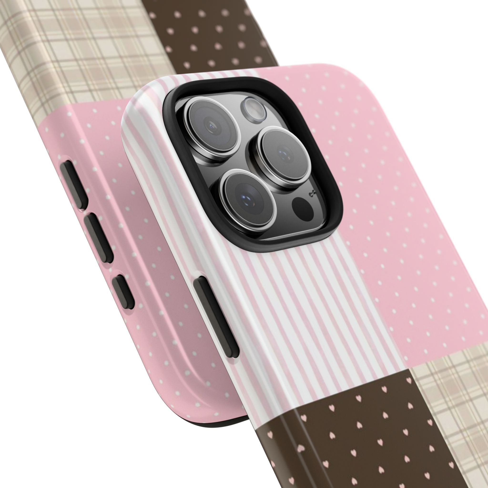 Close-up pink striped and polka dot phone case with plaid panel and dark heart accents
