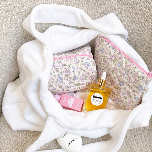 White floral zip pouch with pink zipper trim, open view with patterned lining