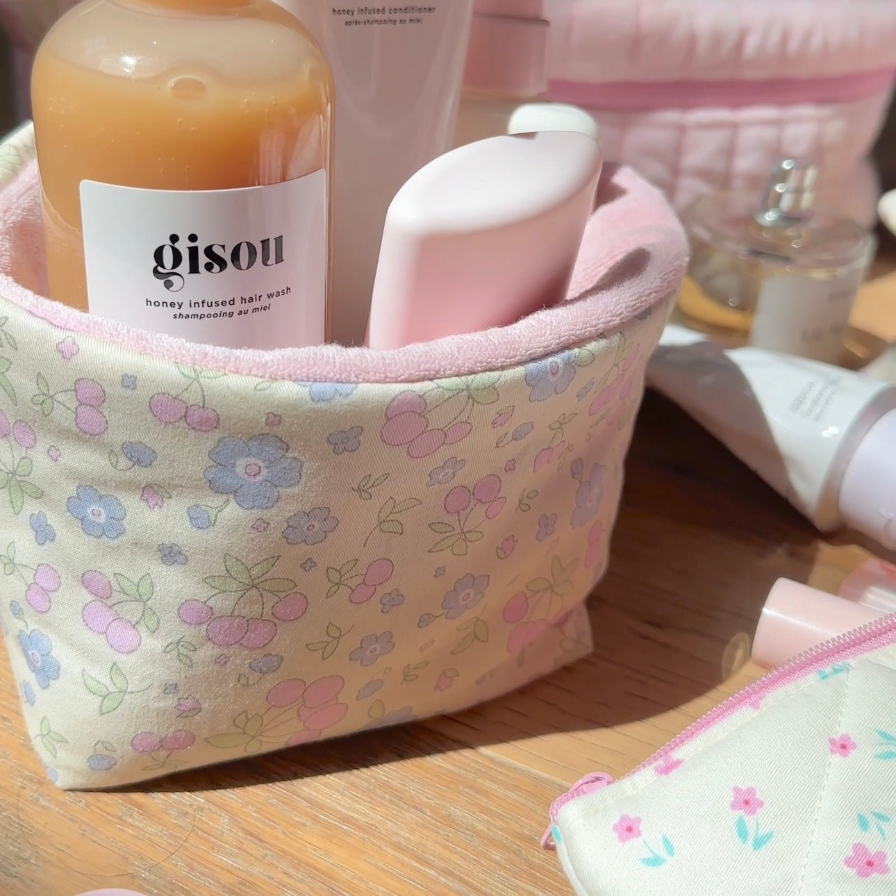 Close-up of pastel floral organizer bin fabric with pink trim and curved opening
