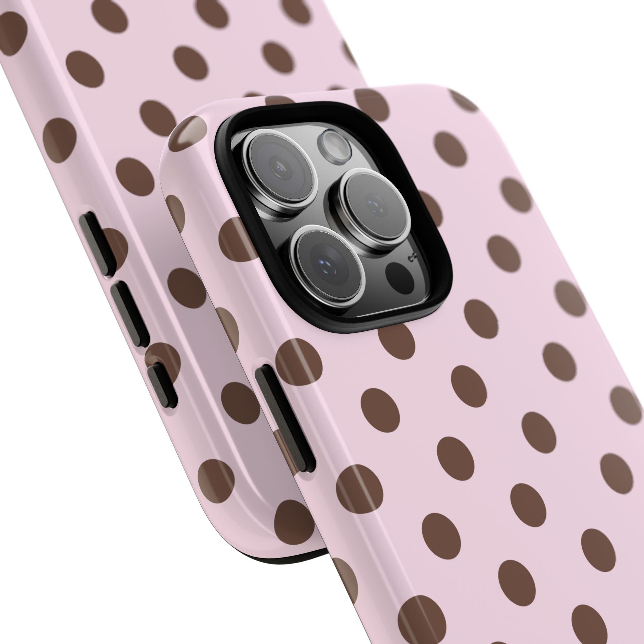 Close-up of pink polka dot phone case showing triple-lens camera cutout and side buttons