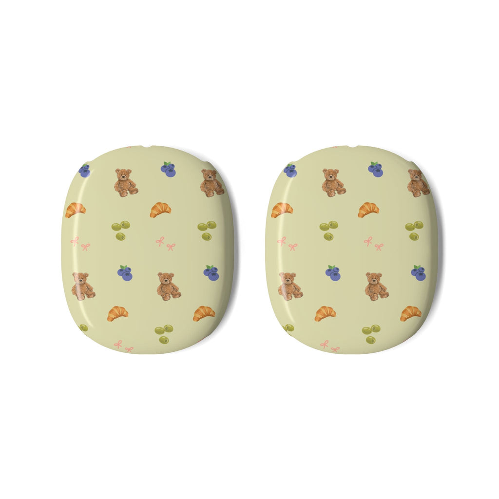 Two AirPods Max ear covers, light yellow with bears, flowers, snacks, and bows pattern