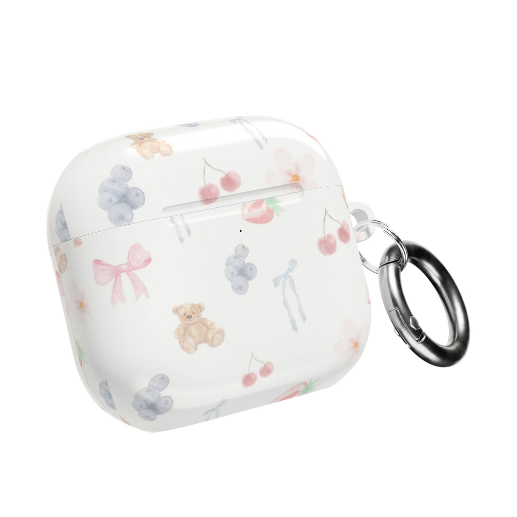 White AirPod case with pastel bear and bow print; metal keyring on side