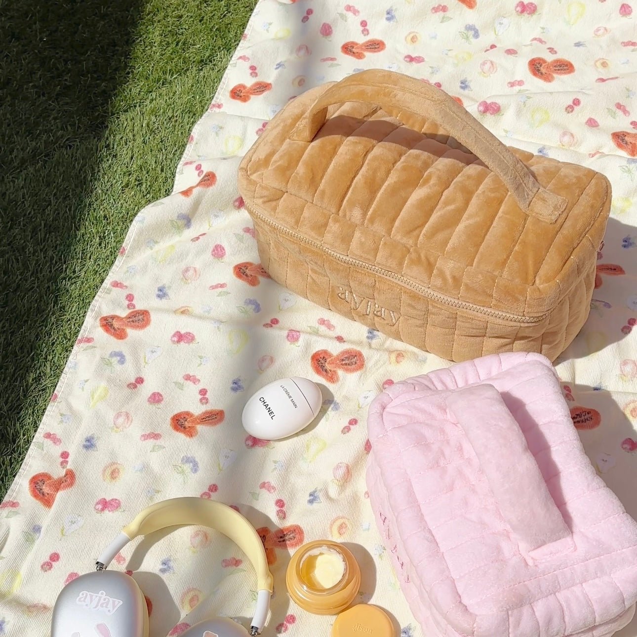 Tan quilted vanity hair tool bag with floral fabric lining and zipper closure.