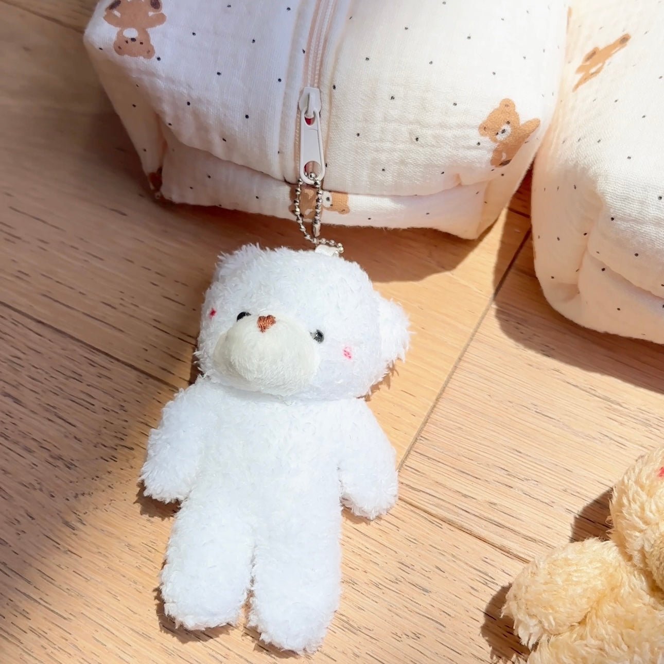 White teddy bear keychain charm with metal clasp, plush animal with button nose