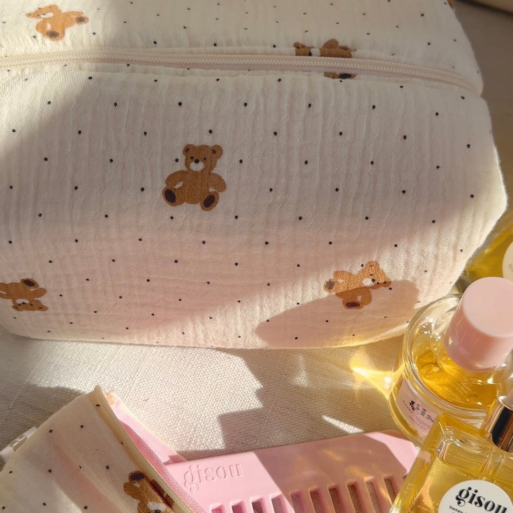 Close-up of cream fabric pouch with teddy bear print and dotted pattern