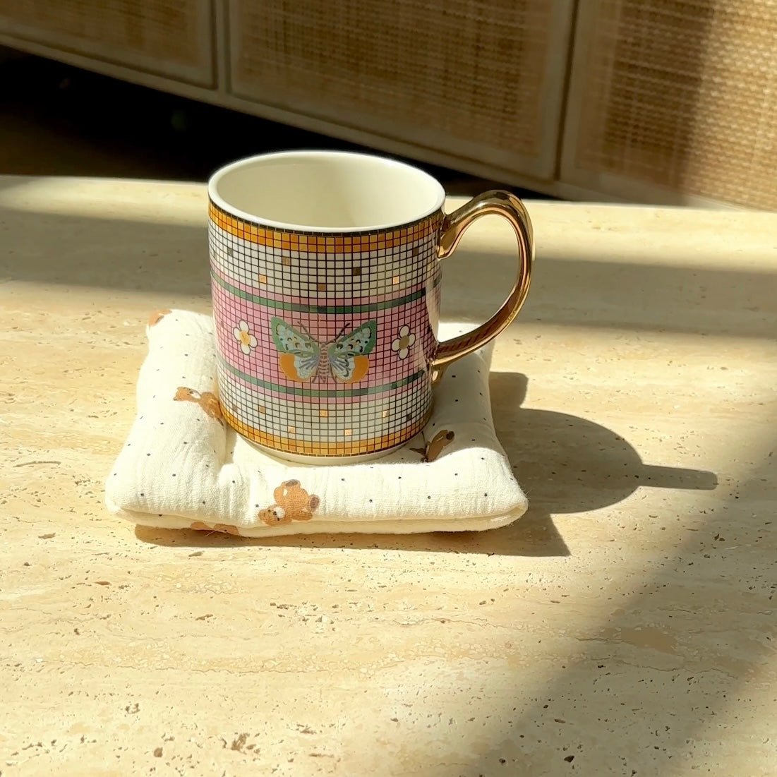 White teddy bear coaster with scattered dots and stitched edges