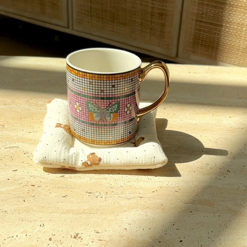 White teddy bear coaster with scattered dots and stitched edges