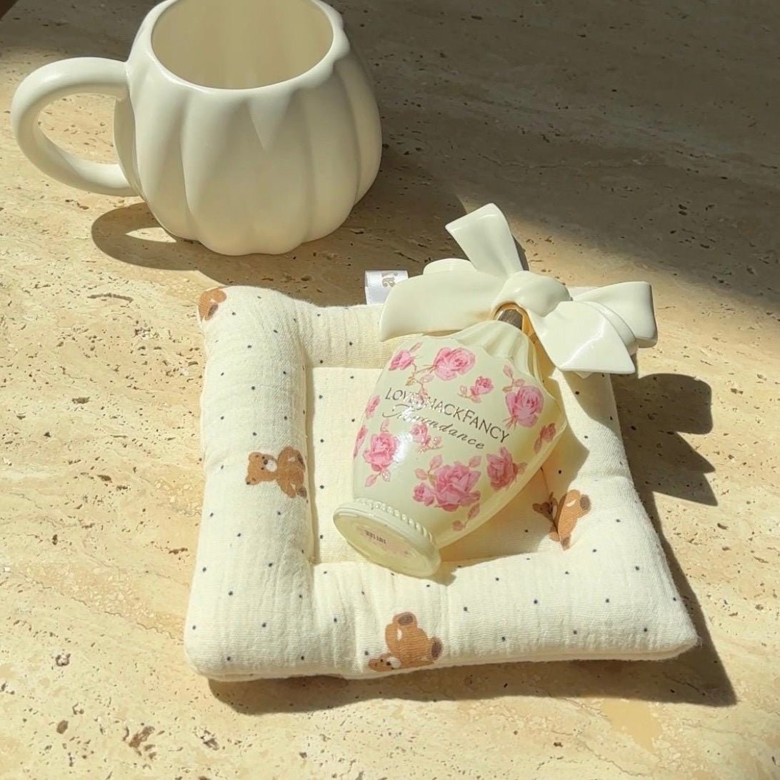 White fabric coaster with small dot pattern and teddy bear prints, square shape