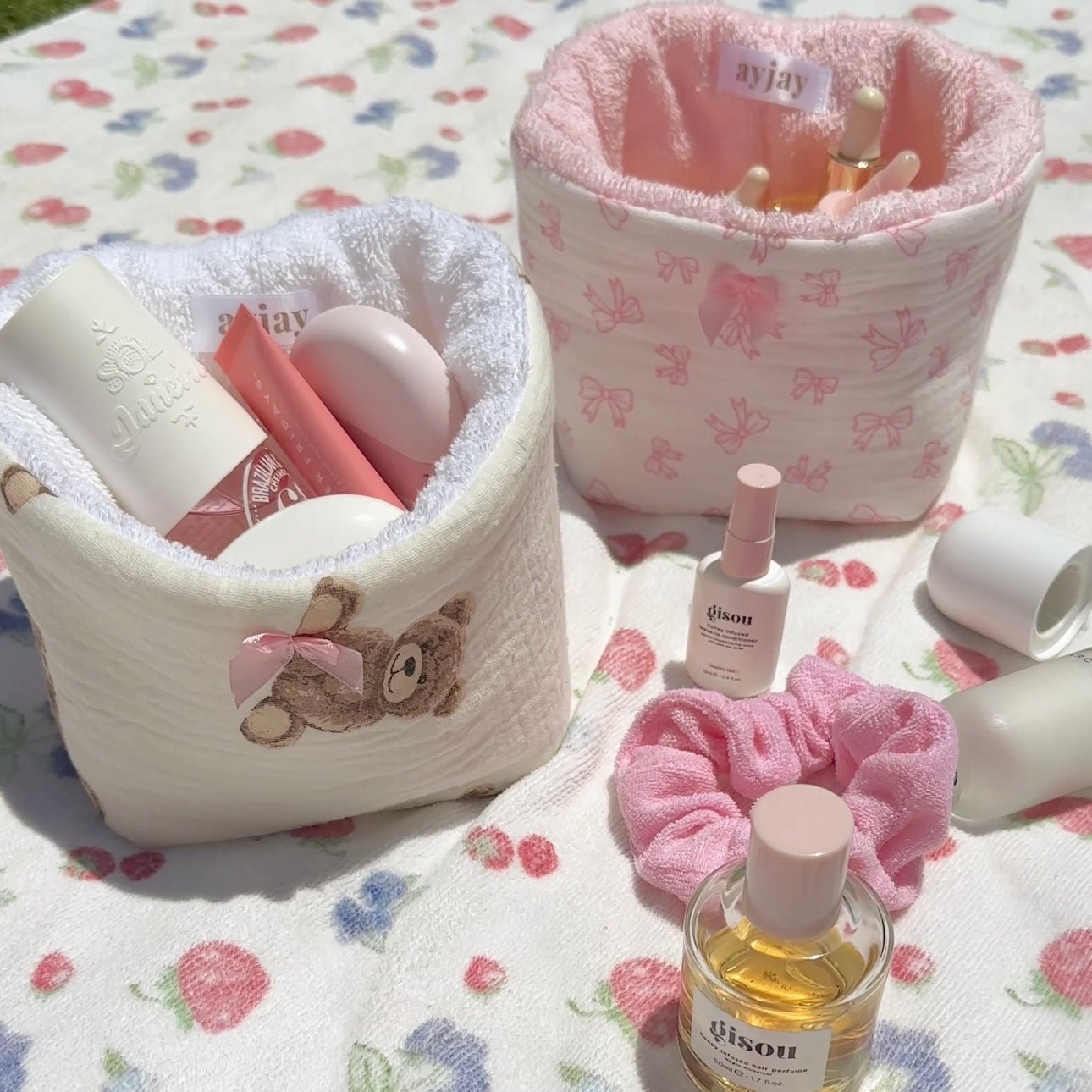 White plush organizer bin with teddy appliqué; pink patterned lining and open interior.