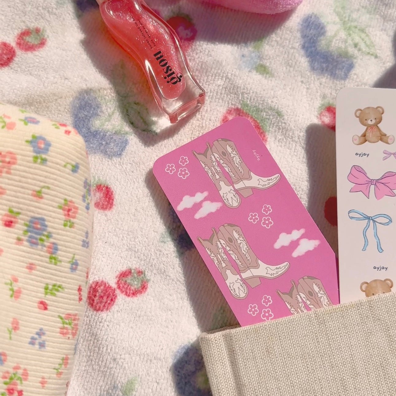 Pink cowgirl-themed paper bookmark card with boots and clouds, beside a teddy bow card.