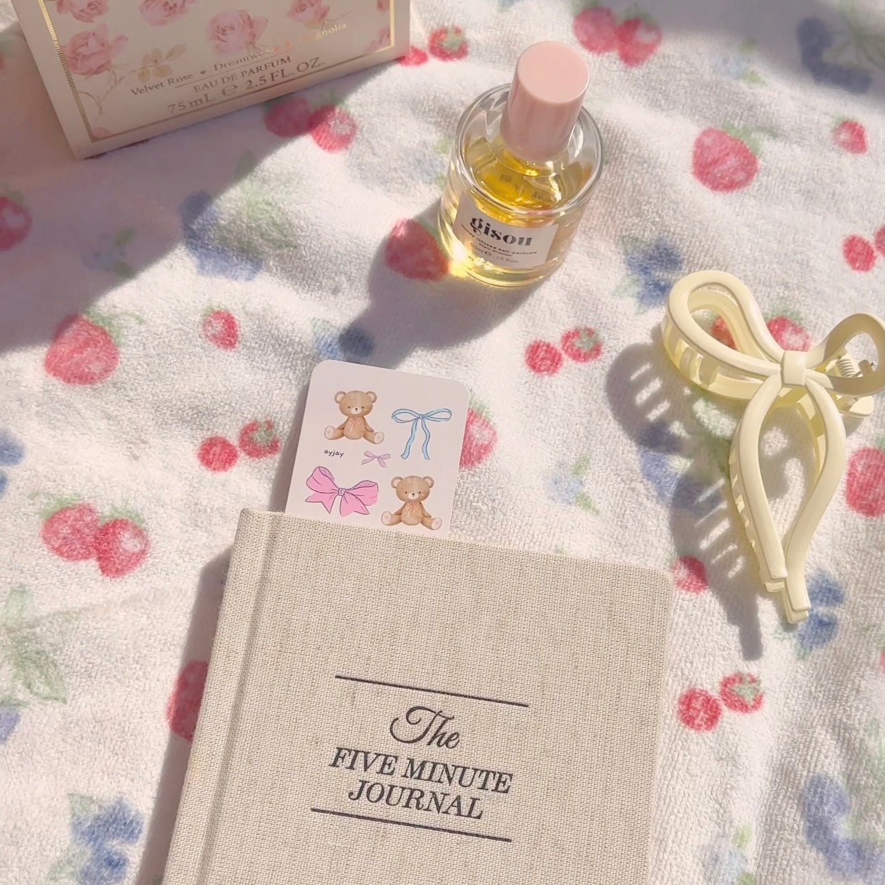 Beige journal with a small paper bookmark card featuring teddy bears and pastel bows.