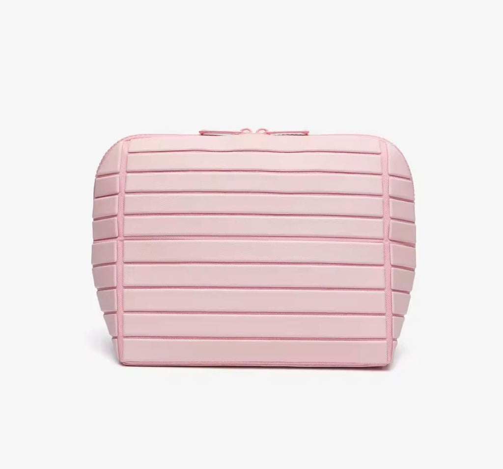 Pink compact flex case with ribbed side panels and top zipper pull
