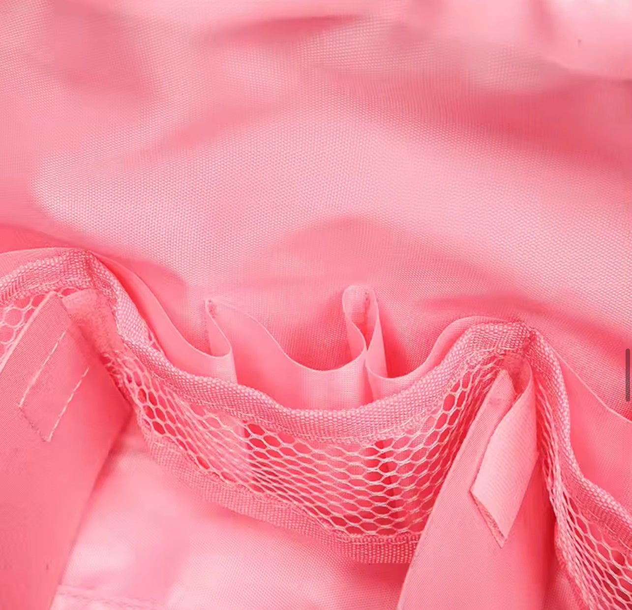 Close-up of pink mesh pocket inside compact flex case with drawstring pouch
