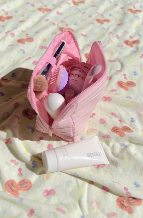 Open pink compact flex case organizer with compartments and beauty tools inside