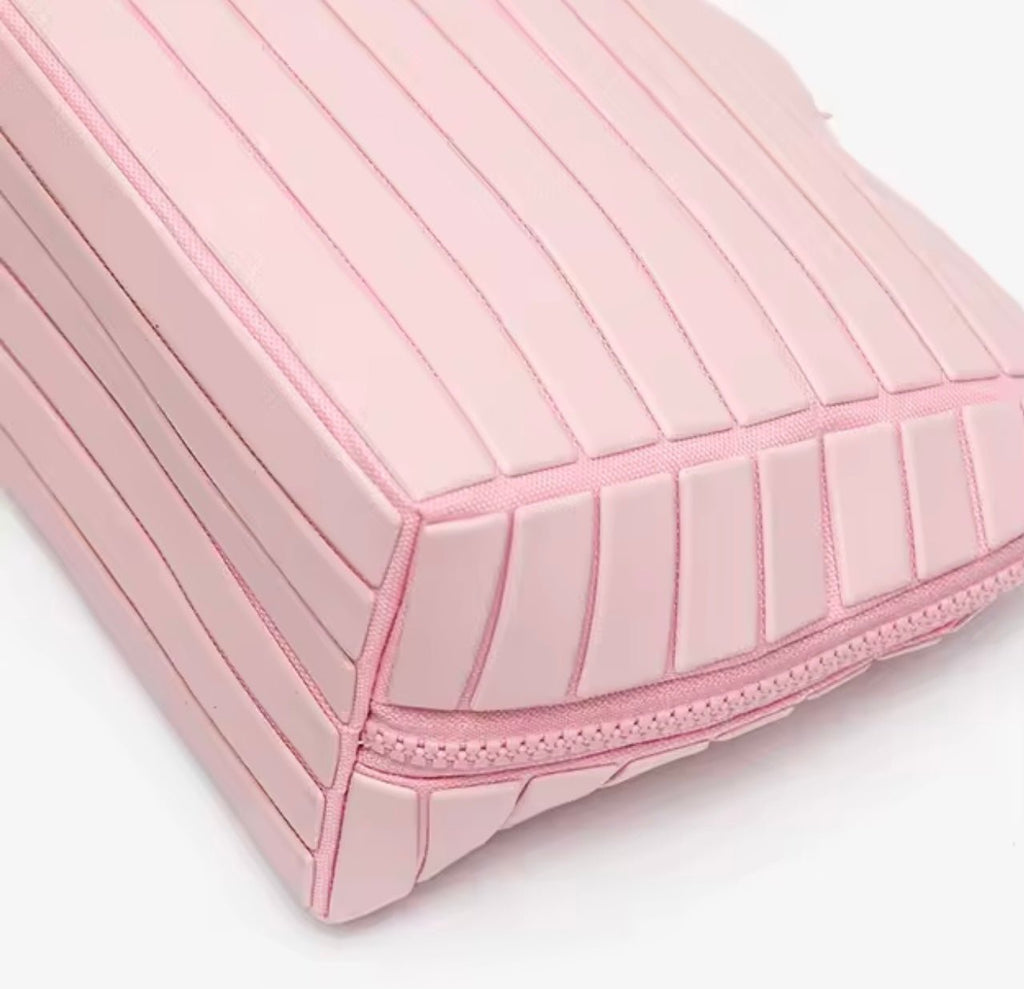 Close-up of pink striped panel design on compact flex case with stitched trim
