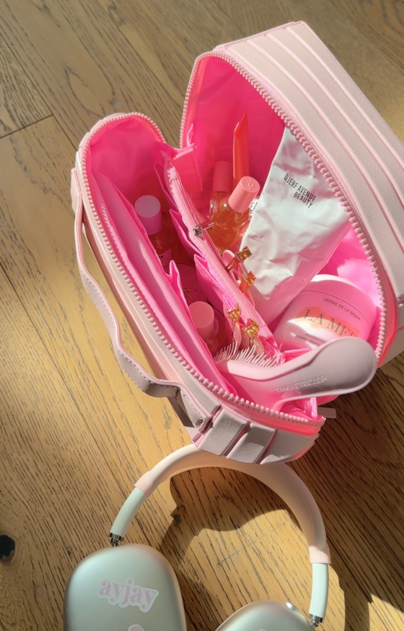 Open ballerina pink XL case with pink interior, pouches, and zippered pockets.