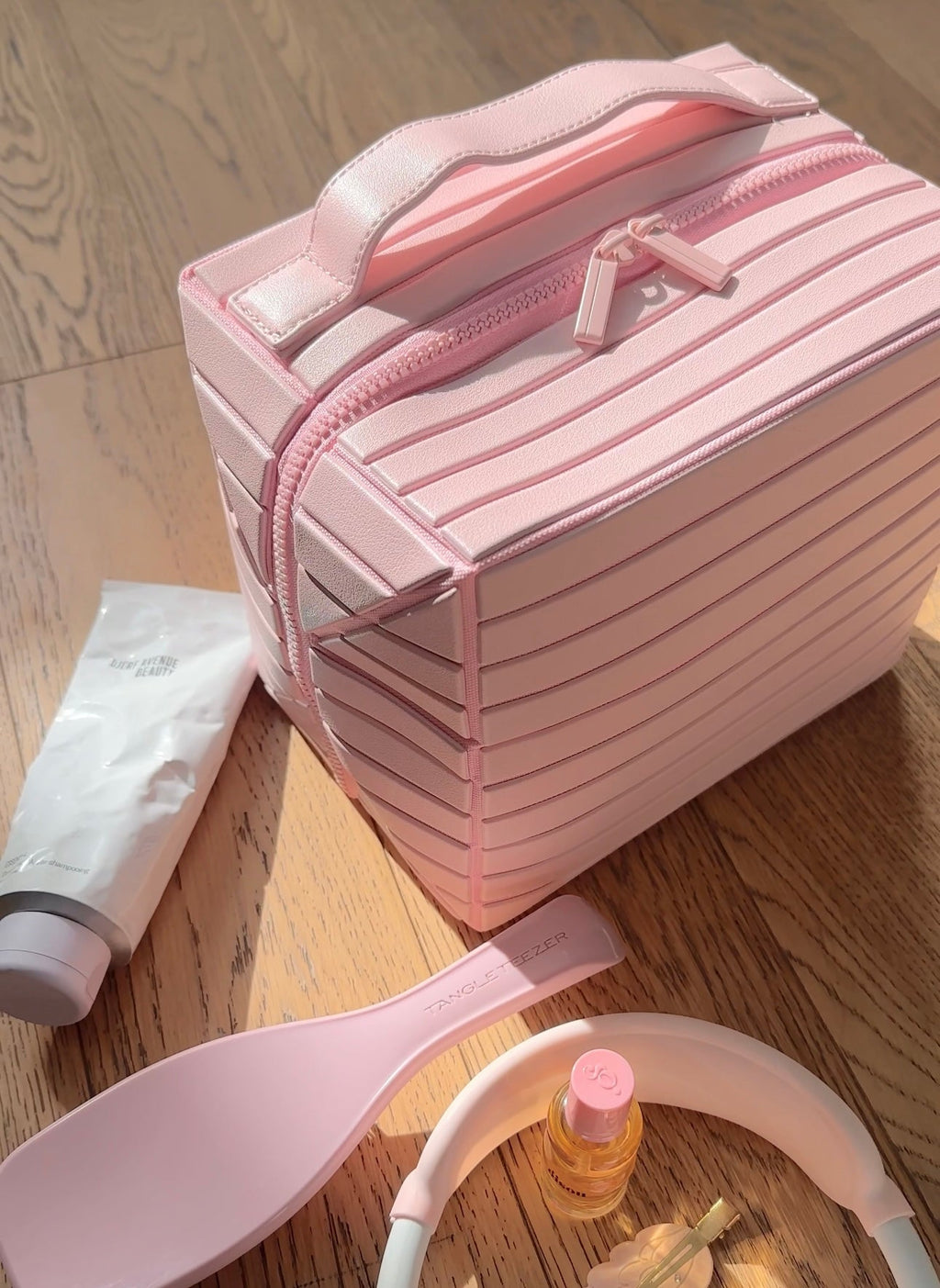 Ballerina pink XL case with striped front, top handle, and zipper front pocket.