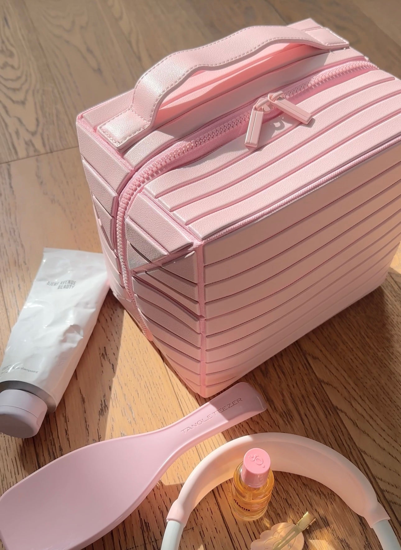 Ballerina pink XL case with striped front, top handle, and zipper front pocket.