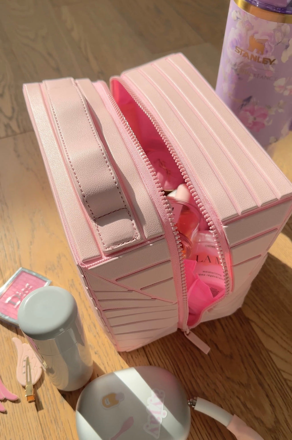 Side view of ballerina pink XL case with two zippers and a textured stripe finish.