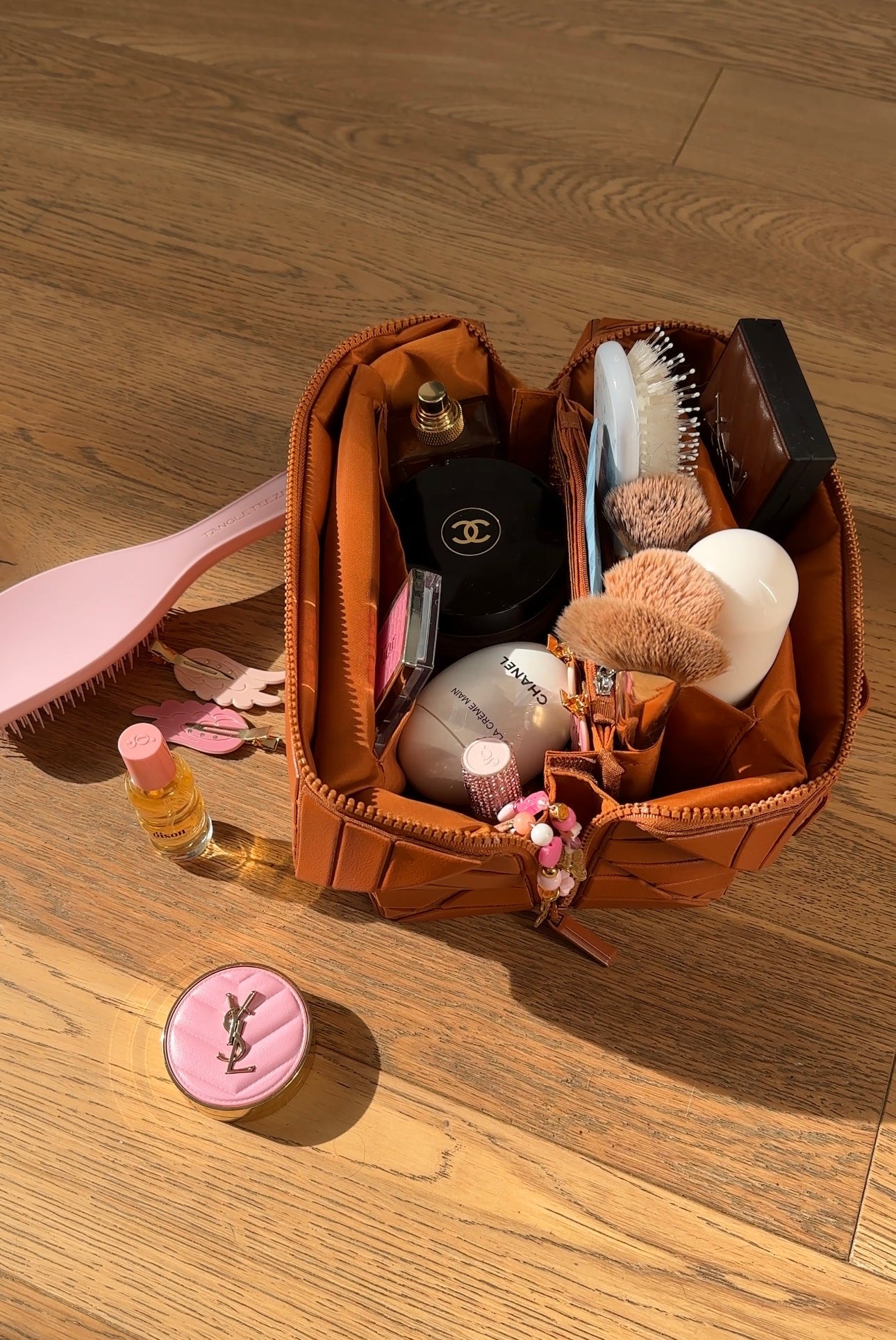 Mocha-brown XL makeup case with open top and multiple compartments holding tools and bottles